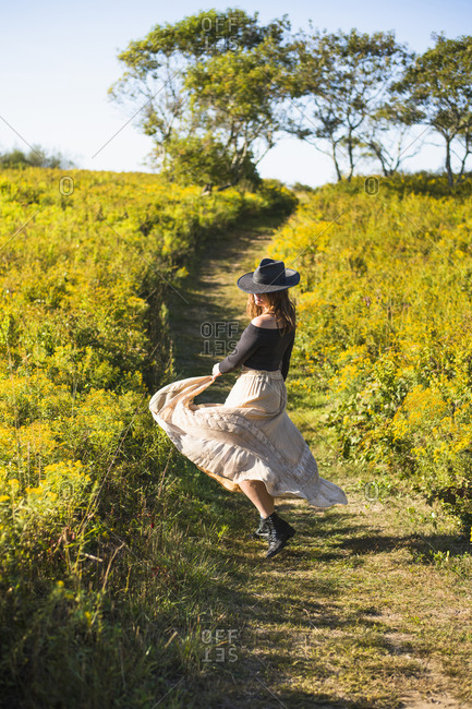 Bohemian vintage prairie cowgirl exploration of nature preserve field