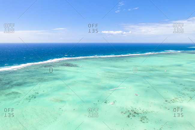 Turquoise coral reef meeting the blue Indian Ocean, aerial view by drone, Ile Aux Cerfs, Flacq district, Mauritius, Indian Ocean, Africa