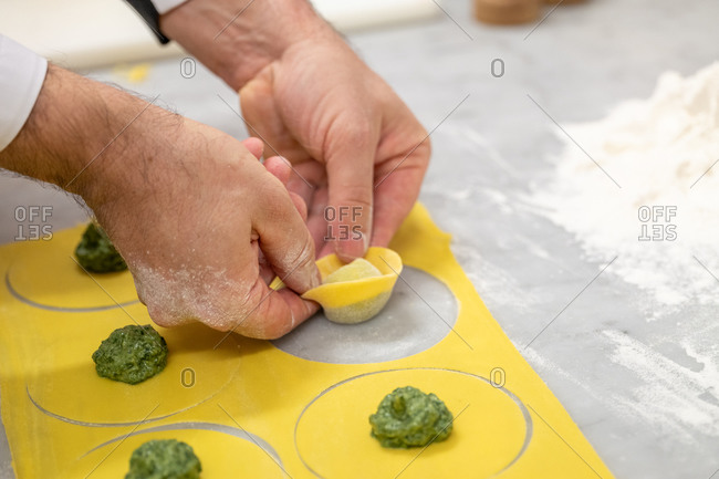 Hands of chef in a restaurant shaping tortellini pasta, Santa Margherita Ligure, Liguria, Italy