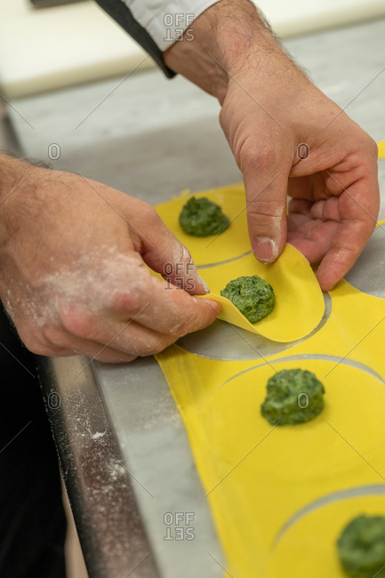 Hands of chef in a restaurant making tortellini pasta, Santa Margherita Ligure, Liguria, Italy