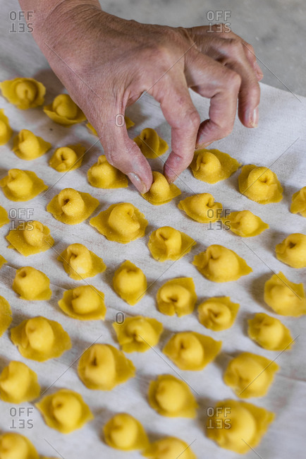 Italian woman making homemade tortellini pasta