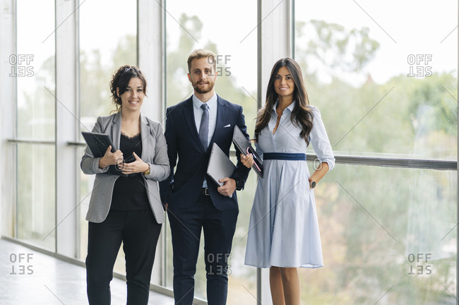 Portrait of confident business team holding portable devices
