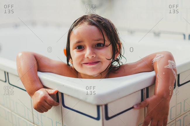 Little girl showering in the bathtub