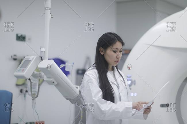 Asian woman doctor checking protocol in a hospital