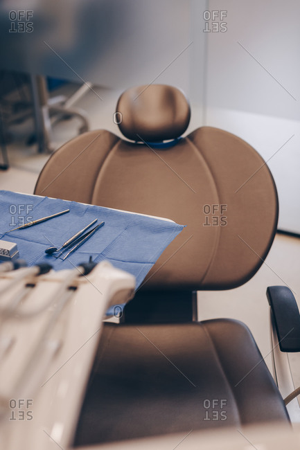 Selective focus on modern patient chair with dentistry tools in the dentist office.