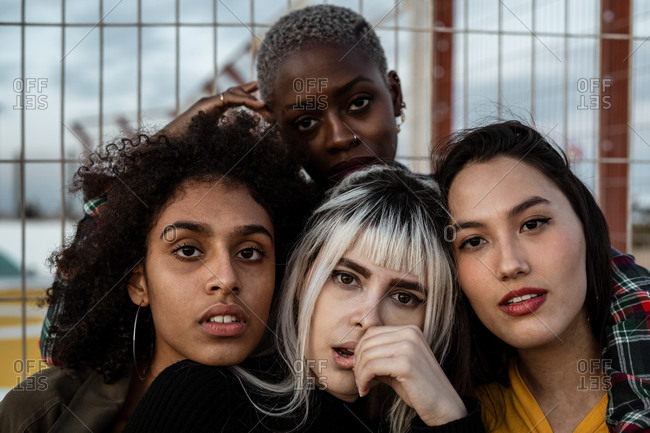 Group portrait of diverse young women wearing clothes in hipster