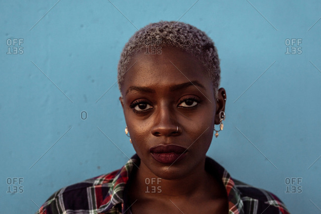Young black short haired woman looking at camera with intense look