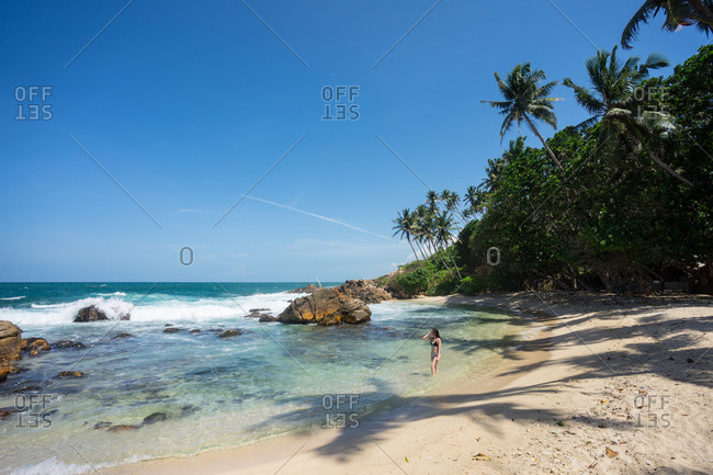 Lady in swimsuit resting on exotic lonely seashore