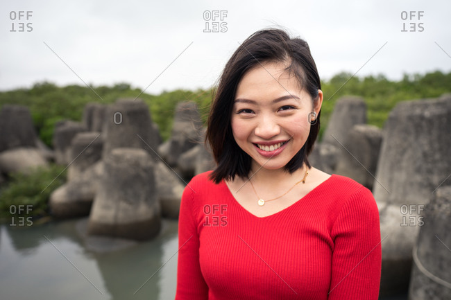 Satisfied Asian woman on vacation during excursion