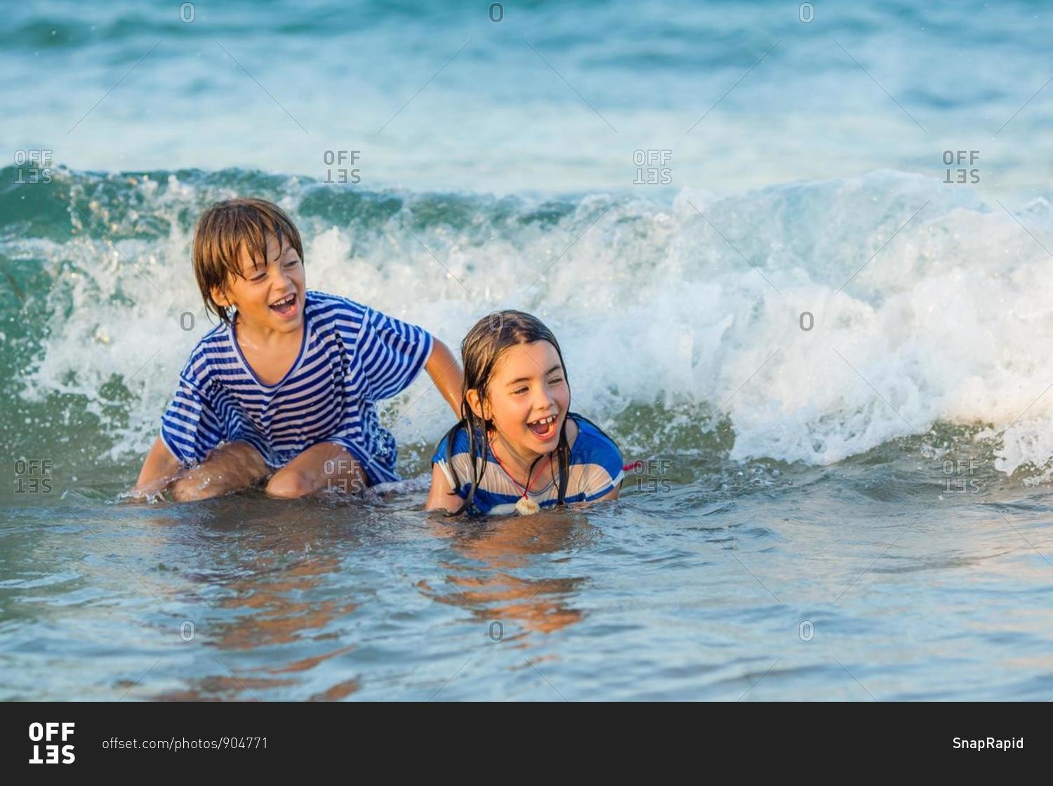 Two happy children playing in the sea