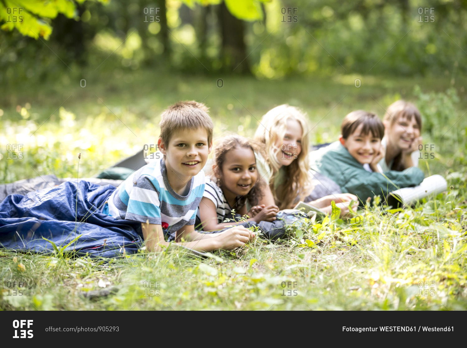 School children camping in forest- lying in sleeping bags stock photo ...