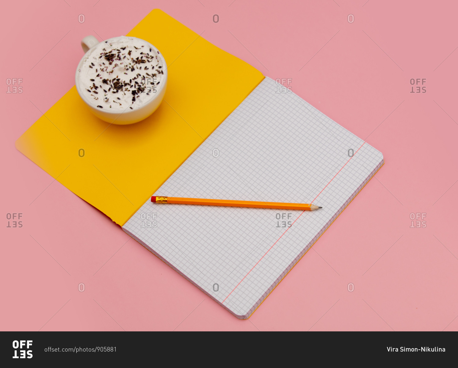 Cappuccino with lavender and notebook with pencil on pink background
