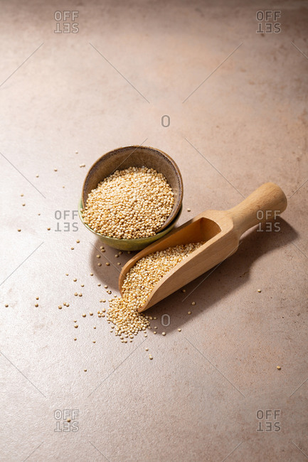 Bowl full of quinoa with wooden scoop