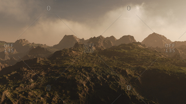 Hazy clouds over rugged mountain landscape