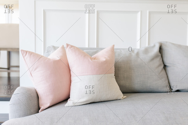 Pink pillows on a grey couch