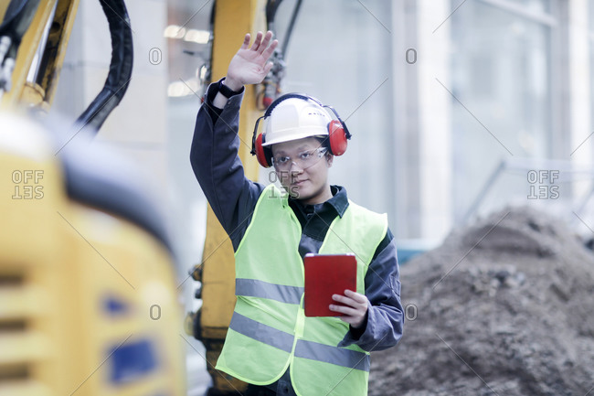 Civil engineer standing in front of an excavator