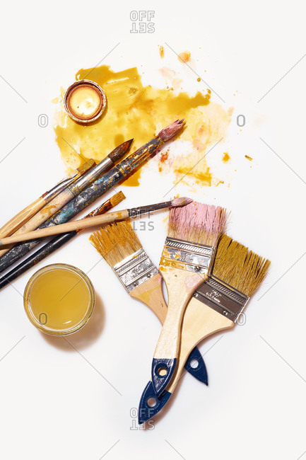 Overhead image of artist's table with paints and tools. Workspace of designer illustrator, messy working atmosphere