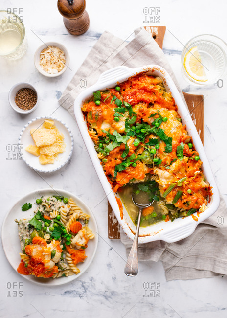 Overhead view of baked macaroni and cheese casserole dish with vegetables and meat