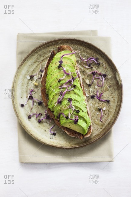 Healthy vegetarian or vegan snack of fresh avocado on toast.