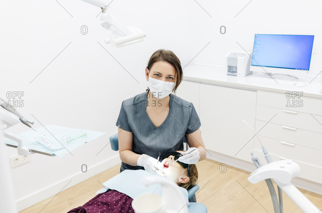 Portrait of dentist examining girl