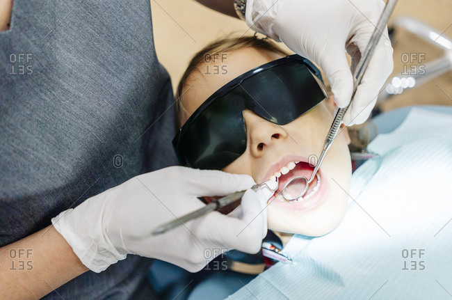 Girl at the dentist receiving treatment