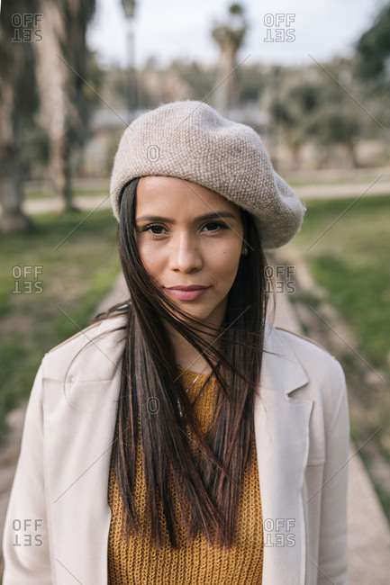 Portrait of young woman with beret in a park