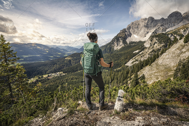 Woman on a hiking trip at Wilder Kaiser enjoying the view- Kaiser mountains- Tyrol- Austria