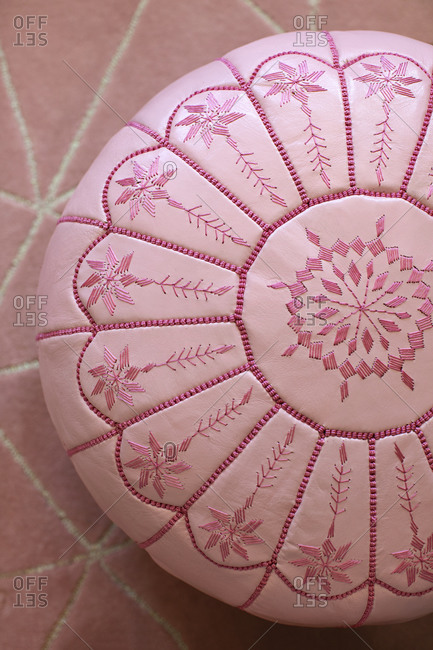 Pink cushion with threaded design