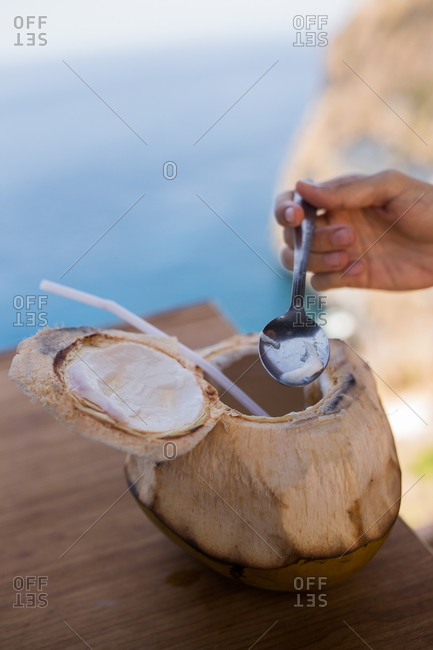 Woman scooping coconut meat in Bali, Indonesia