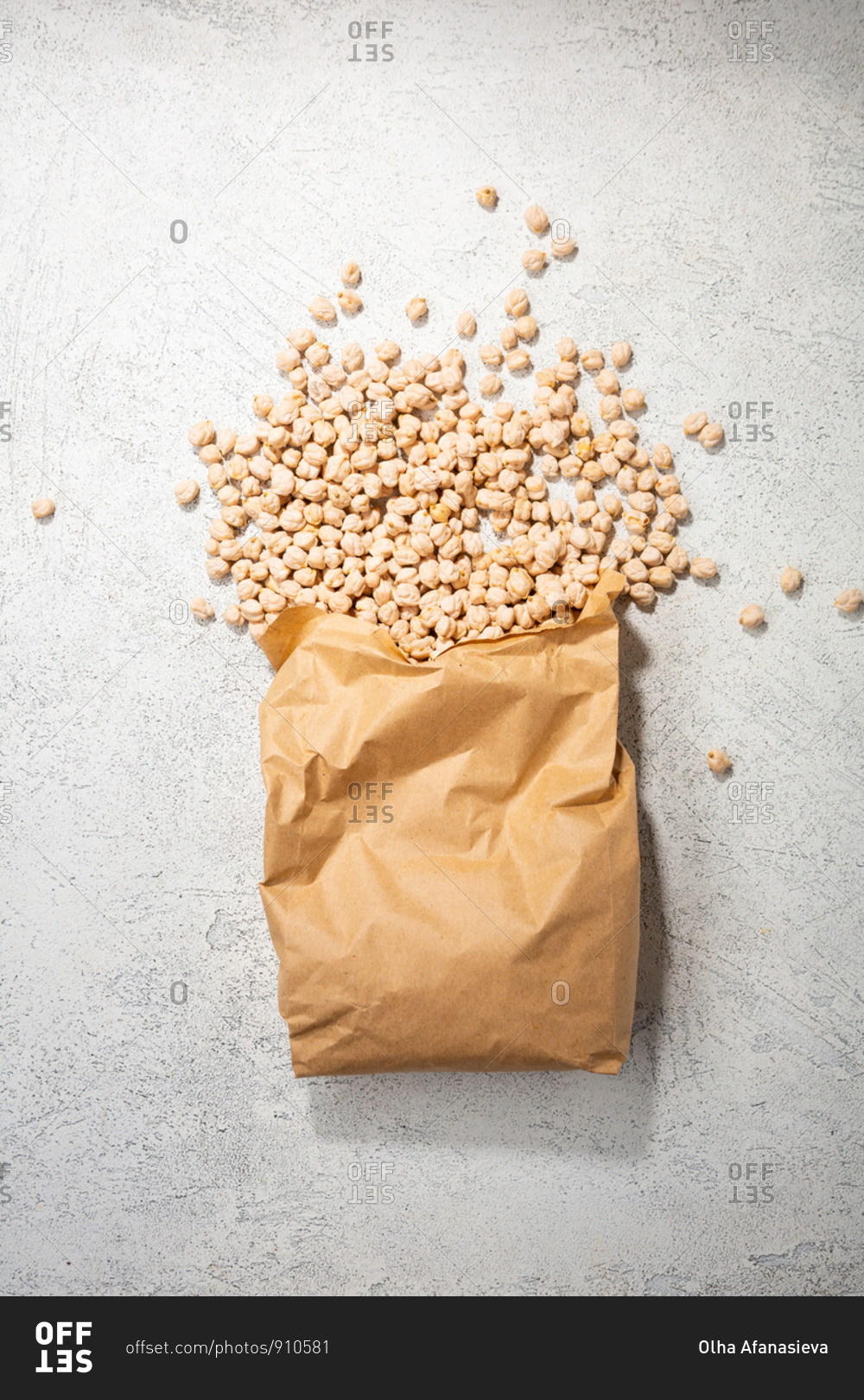 Overhead view of chickpeas spilling out of paper bag