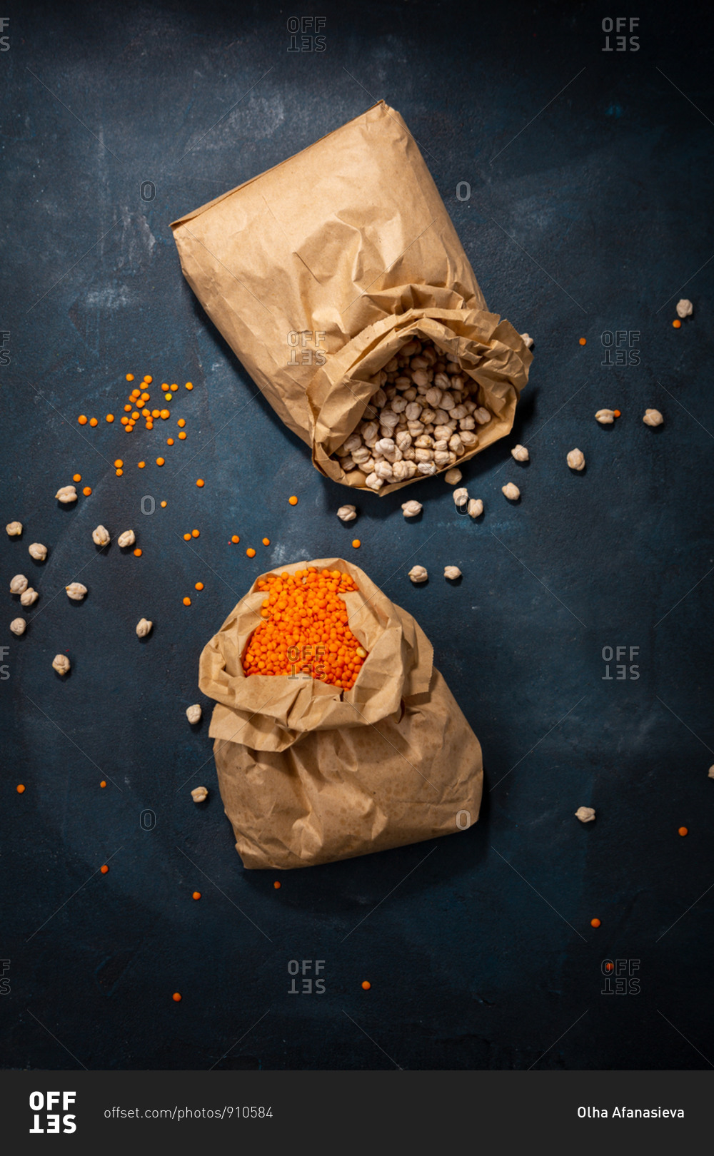 Overhead view of chickpeas and red lentils in paper bags