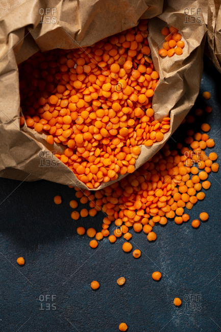 Close up of red lentils in a wrinkled paper bag