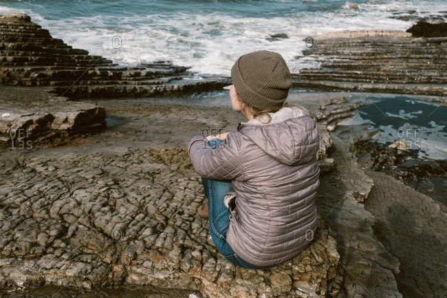 Woman looking out at the ocean in contemplation