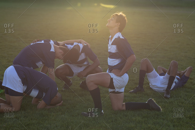 Rugby players stretching after the match