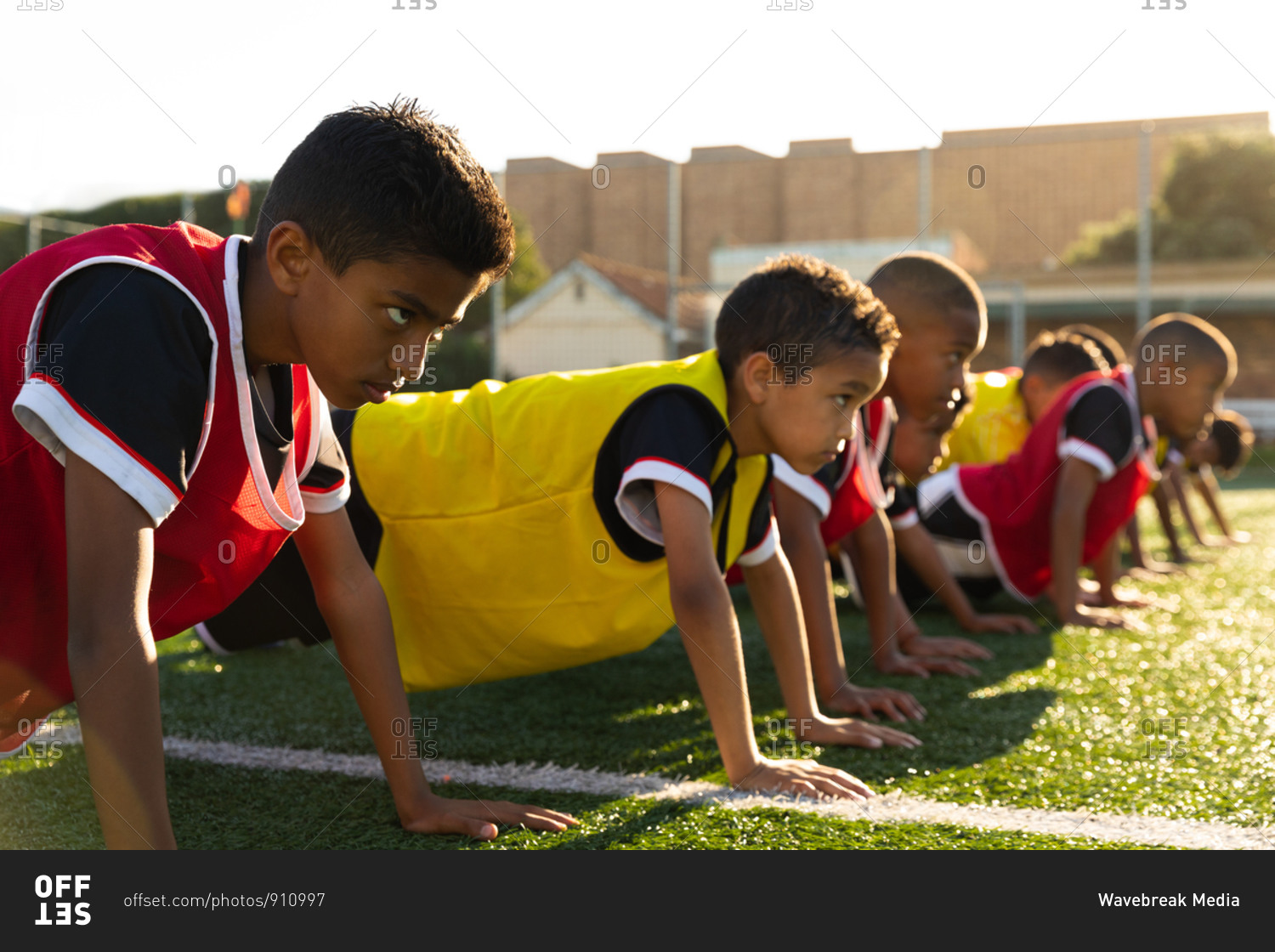 Side view soccer players doing push ups