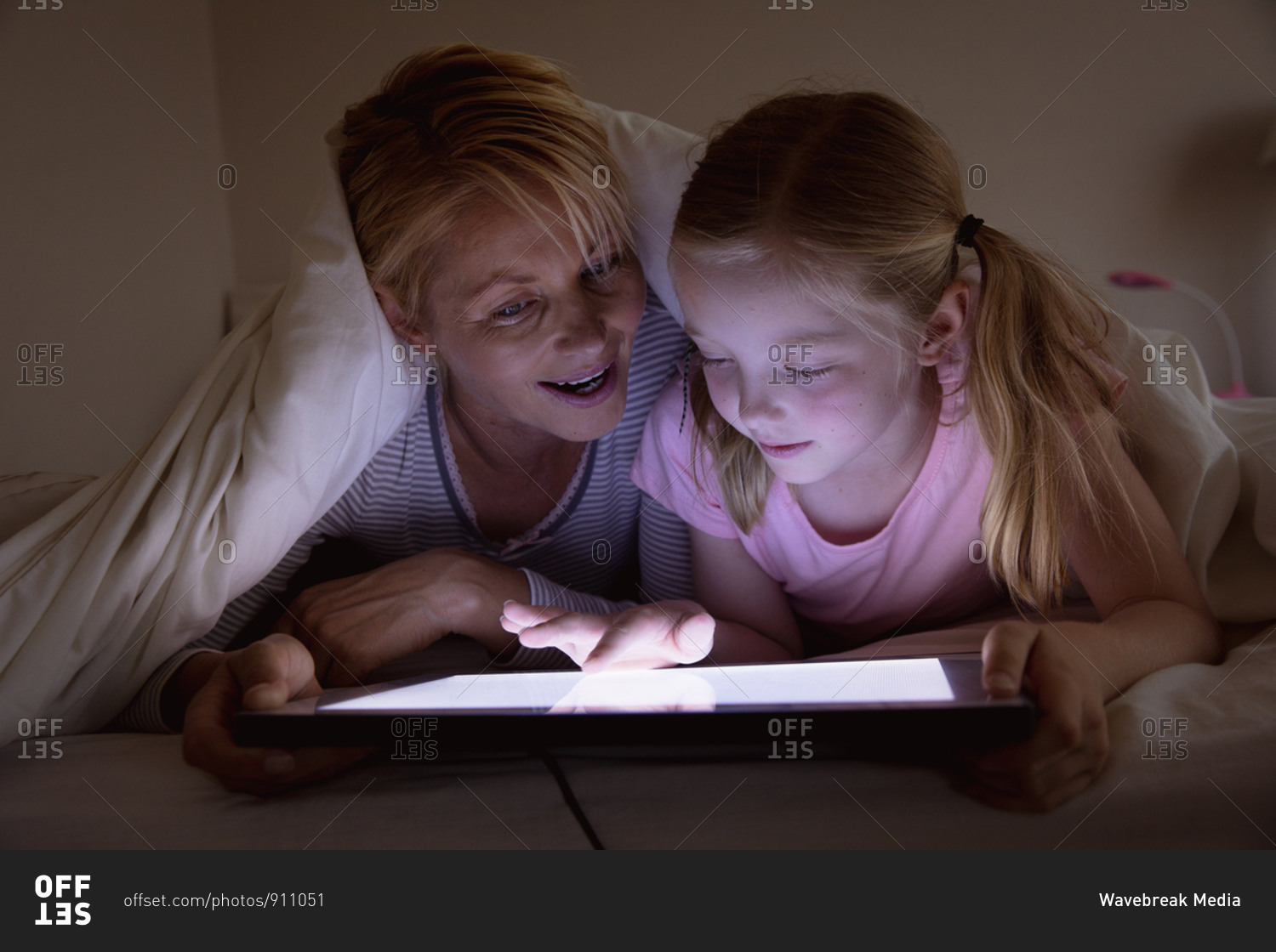 Mother and daughter using digital tablet together