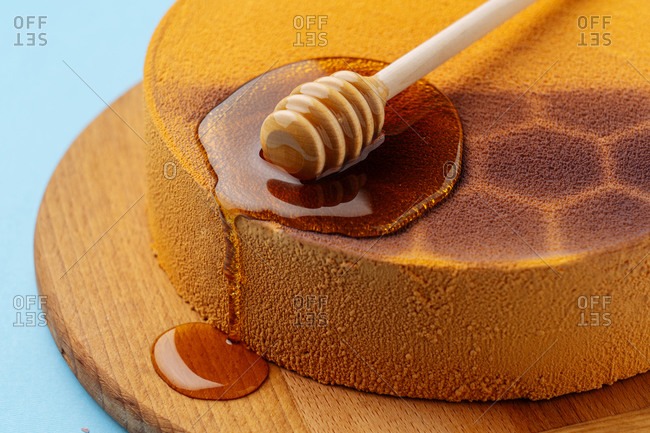 Honey spoon on honeycomb cake