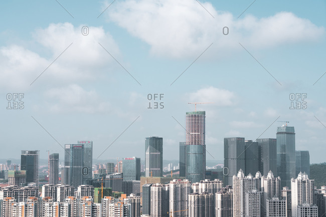 June 26, 2018: June 26, 2018: Exterior shot of modern highrise glass towers and buildings under blue sky in cityscape of Nanning, China