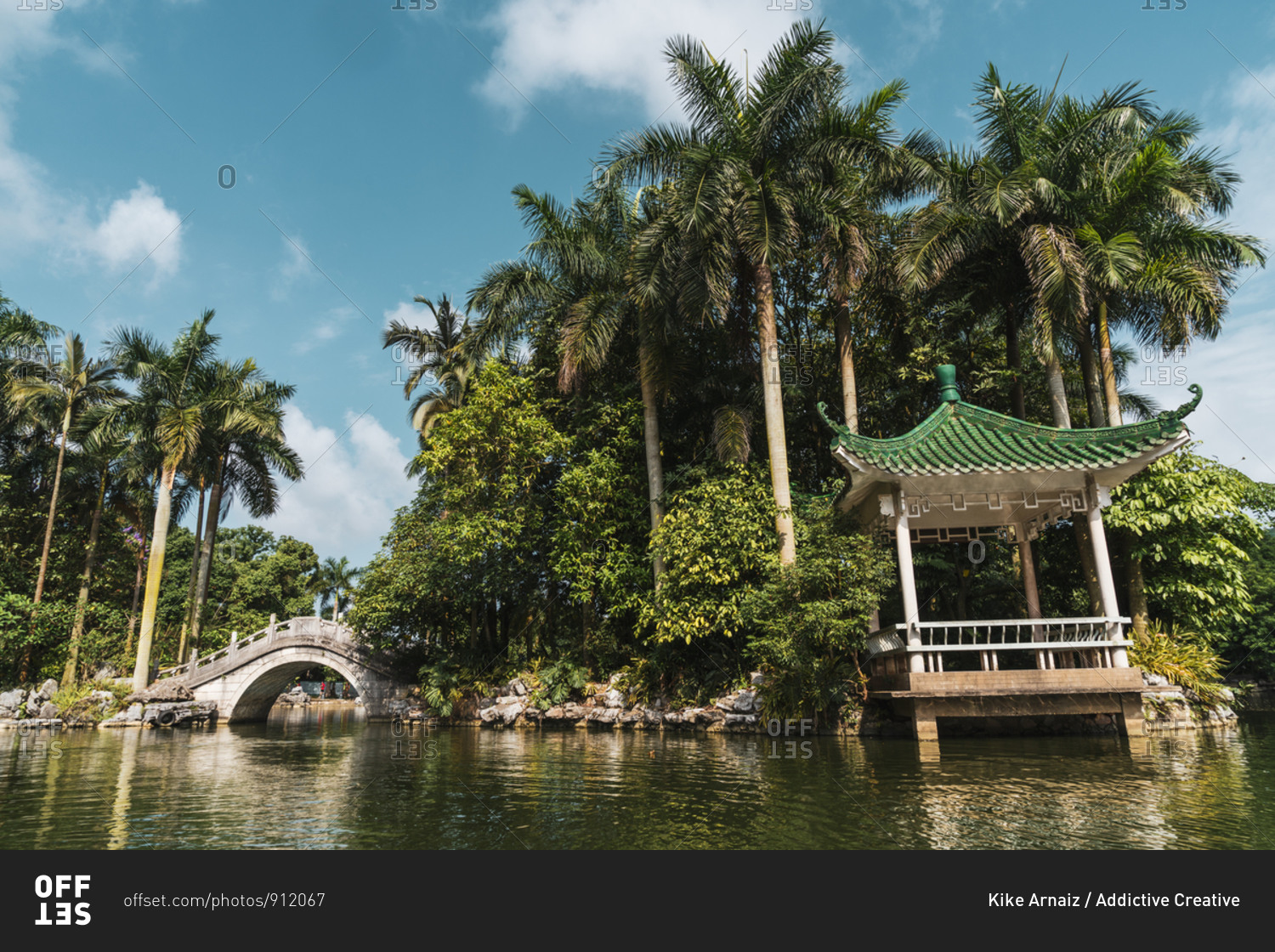 Stone oriental bridge on tropical park