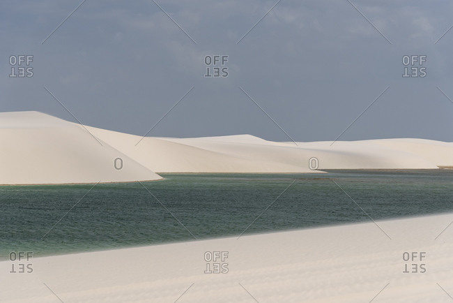 Beautiful view to white sand dunes and crystal clear rainwater pool