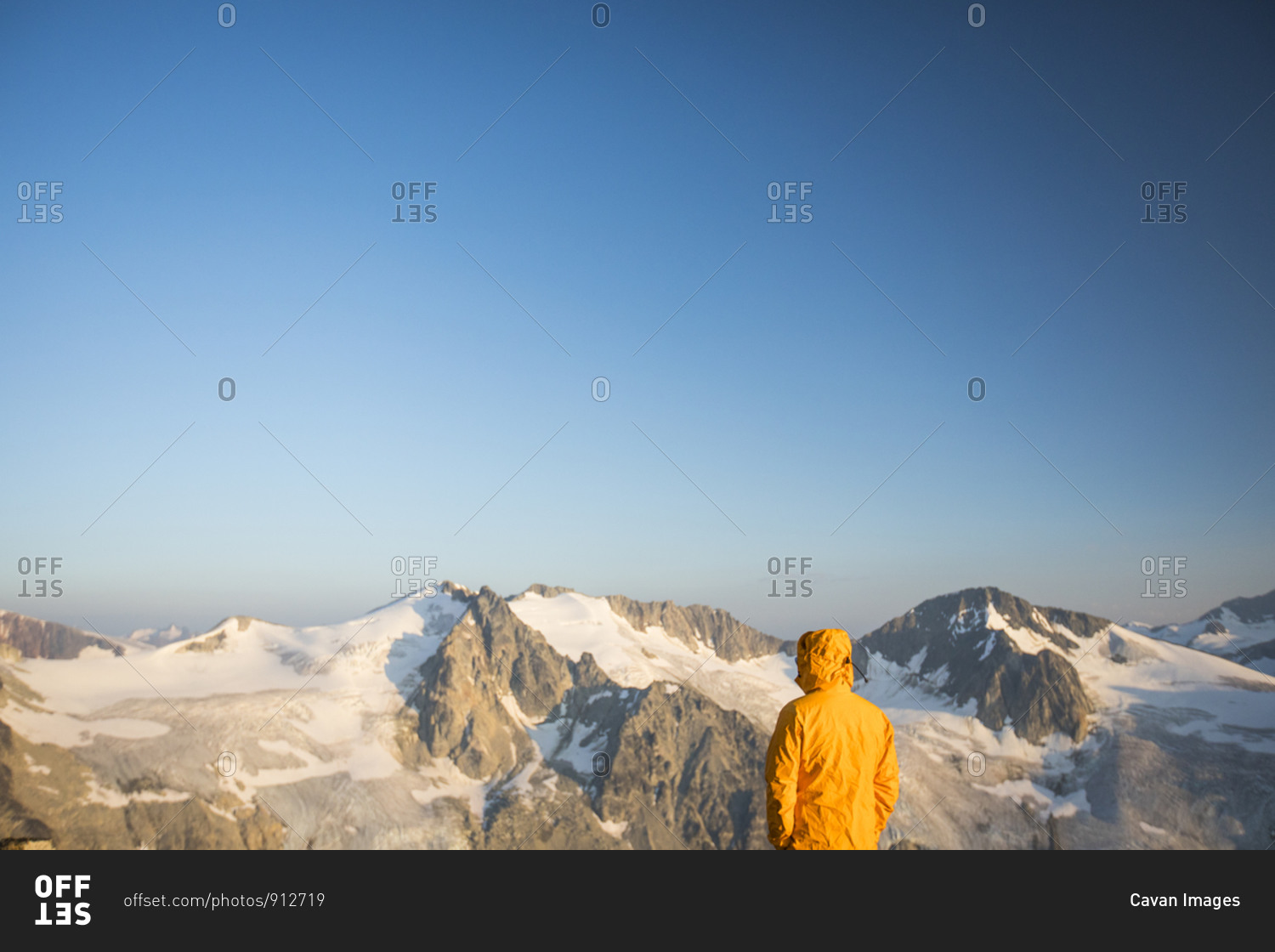 Hiker looking at view of glaciated mountains in Canada.