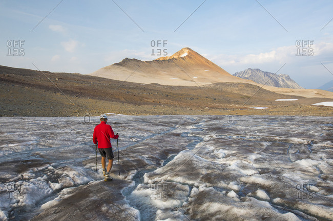 hiker crosses glacier towards Ochre Mountain.
