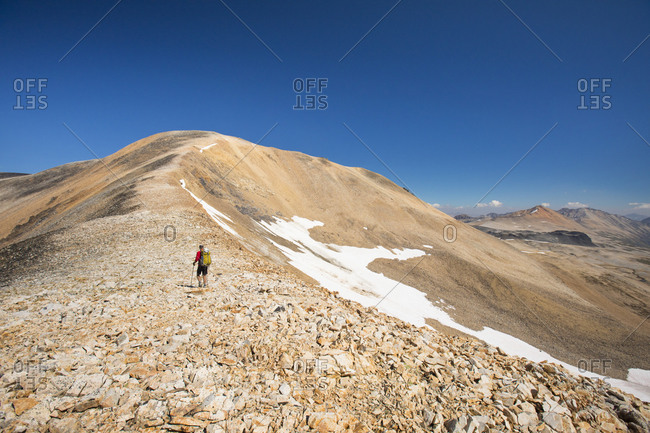 Hiking over endless rocky ridge in the mountains.