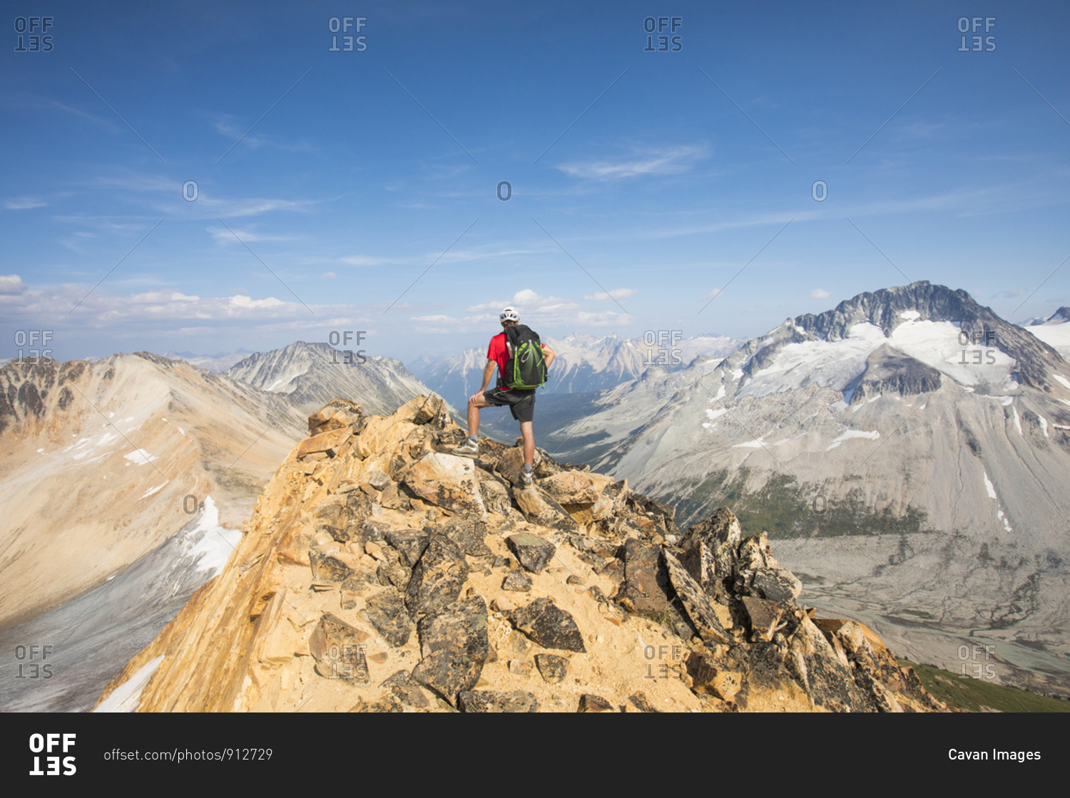 Hiker standing on summit of Ochre Mountain, Canada.