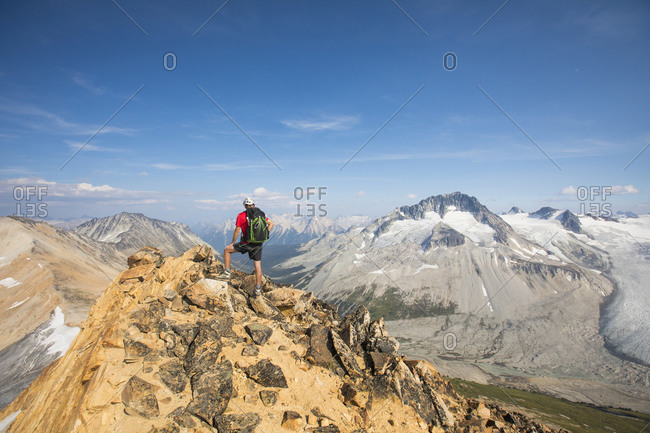 Backpacker standing on mountain summit.