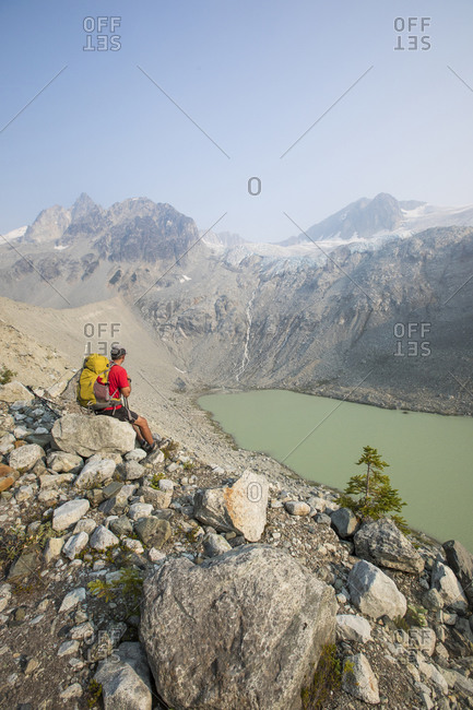 Hiker takes a break with view, Athelney Pass, British Columbia, Canada