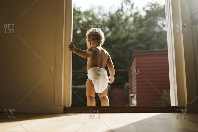 Toddler standing in open door