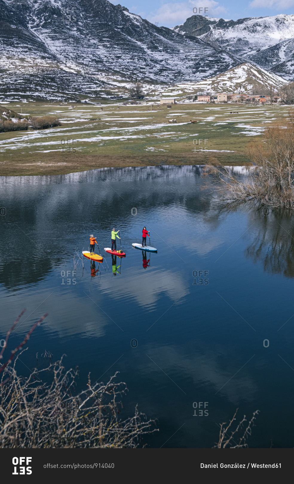 Aerial view of three people stand up paddle surfing- Leon- Spain