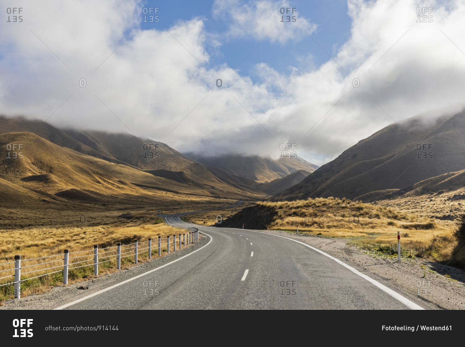 New Zealand- Clouds over empty State Highway 8 in Lindis Pass