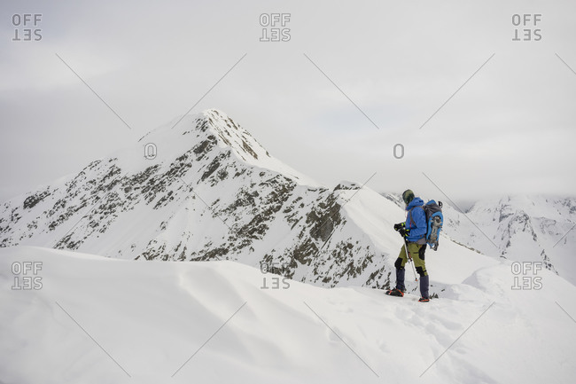 Man on an excursion on the crest of a snowy mountain- Lombardy- Valtellina- Italy